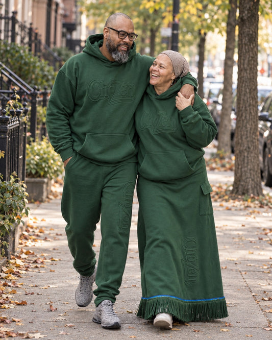 Couple in the ChoZen embossed forest green hoodie, joggers and maxi skirt